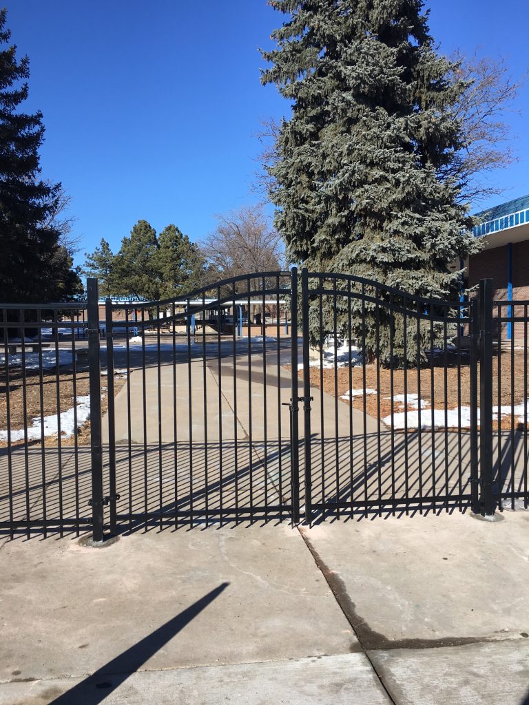 black double drive gated fence for a home